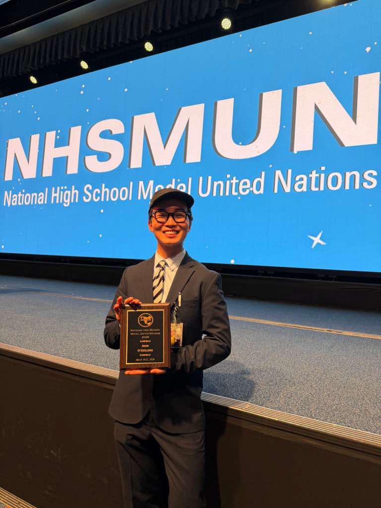 joshua holding a model un award at nhsmun